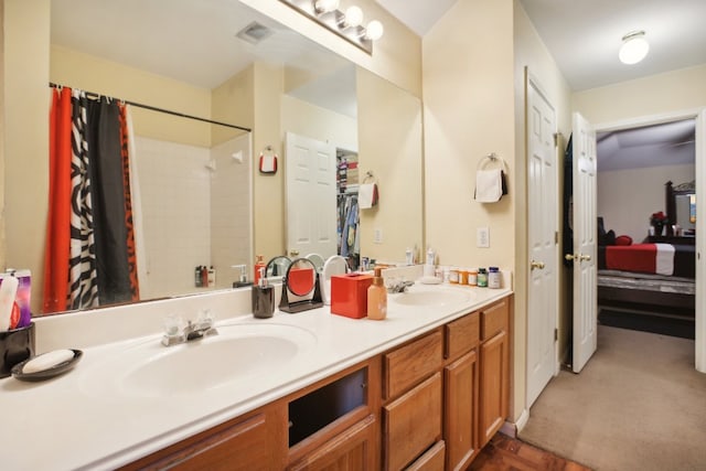 bathroom featuring vanity and a shower with shower curtain