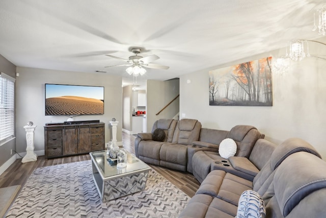 living room featuring wood-type flooring and ceiling fan