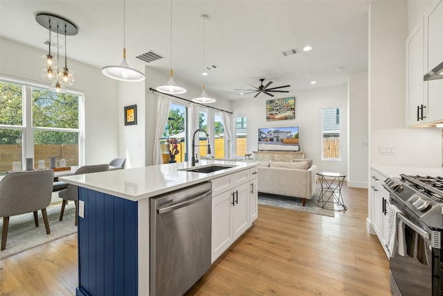 kitchen featuring visible vents, light wood-type flooring, a sink, range with gas stovetop, and stainless steel dishwasher