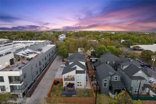 aerial view at dusk featuring a residential view