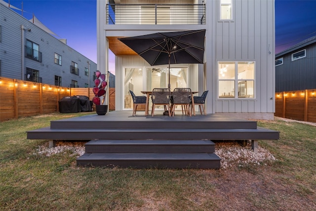 deck featuring a lawn, area for grilling, and a fenced backyard