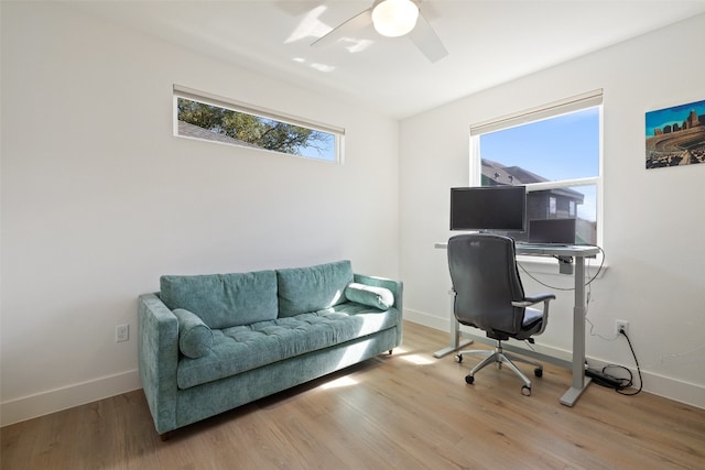 office featuring a wealth of natural light, baseboards, and light wood-style floors