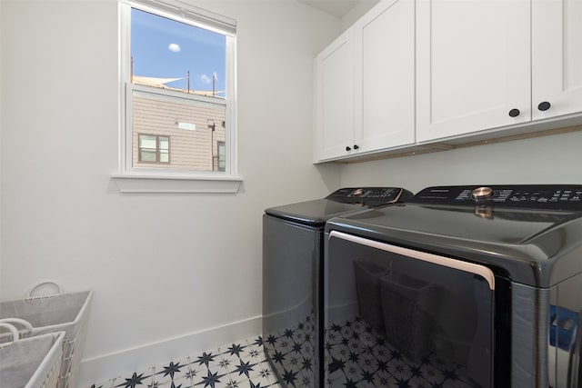 washroom featuring tile patterned floors, cabinet space, baseboards, and washer and clothes dryer