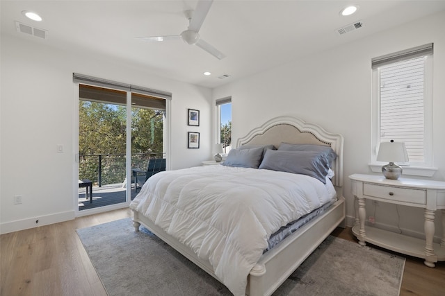 bedroom with access to outside, wood finished floors, and visible vents