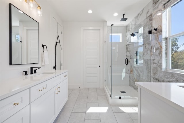 full bath with recessed lighting, baseboards, vanity, and a shower stall