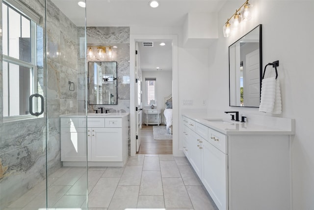 full bathroom featuring two vanities, a sink, recessed lighting, connected bathroom, and a shower stall