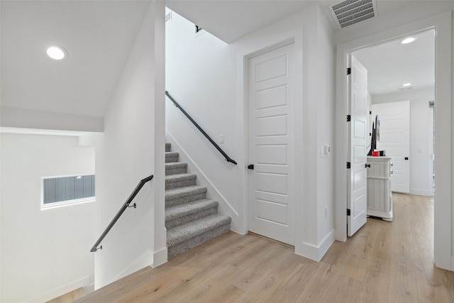 stairs featuring visible vents, recessed lighting, baseboards, and wood finished floors