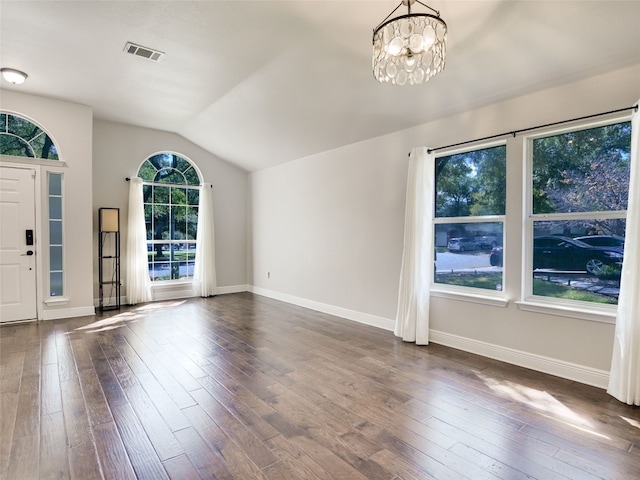 interior space featuring lofted ceiling, a chandelier, and dark hardwood / wood-style flooring