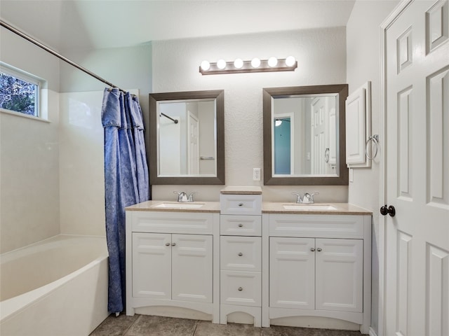 bathroom featuring vanity and shower / bathtub combination with curtain