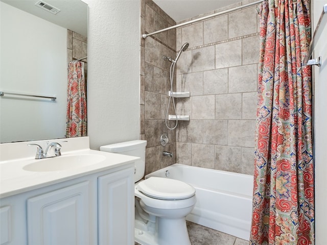 full bathroom featuring vanity, shower / bath combo with shower curtain, toilet, and tile patterned floors