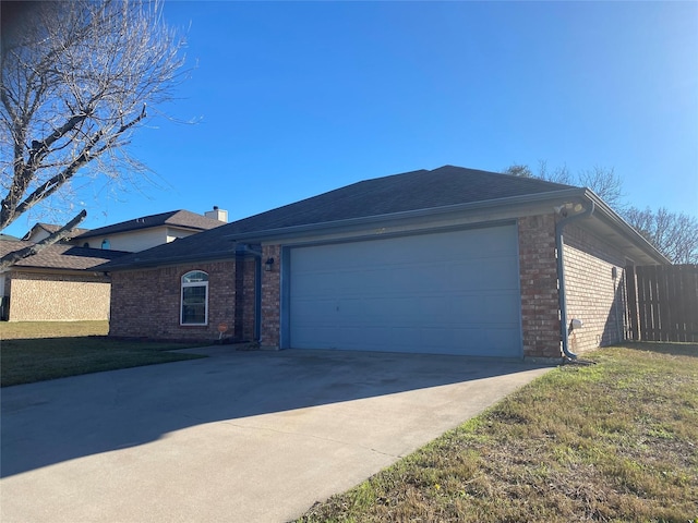 single story home featuring a front yard and a garage