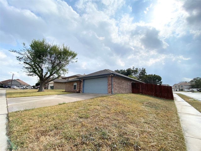 view of front of property with a front yard and a garage