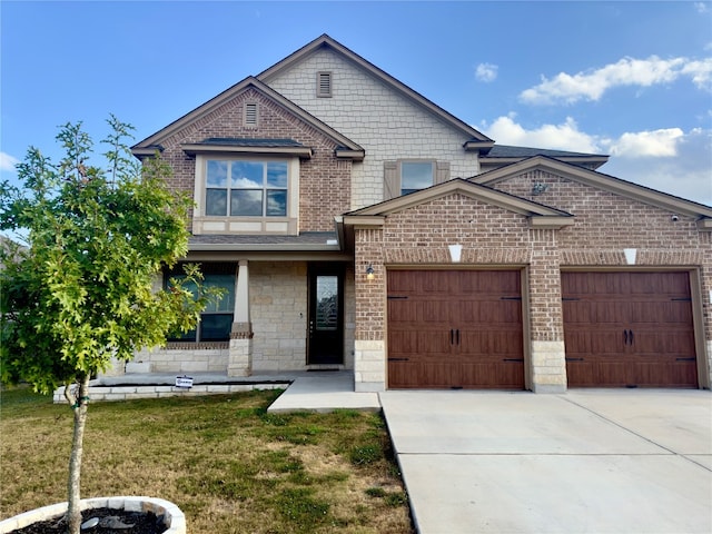 view of front of home featuring a front yard and a garage