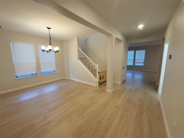 interior space featuring an inviting chandelier and light wood-type flooring