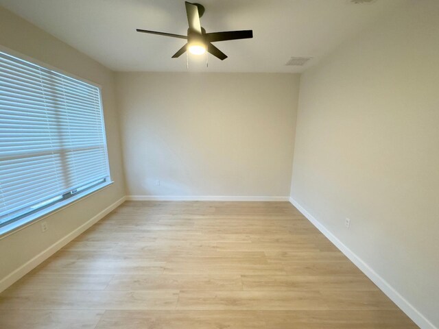 spare room with light hardwood / wood-style flooring and ceiling fan