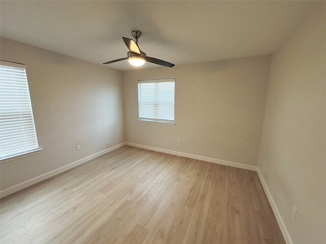 unfurnished room with a healthy amount of sunlight, light wood-type flooring, and ceiling fan