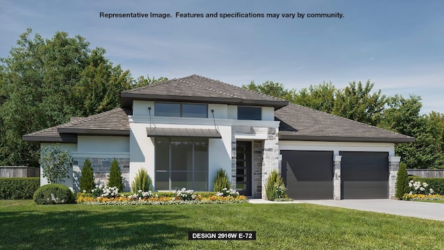 view of front of house with a garage and a front lawn