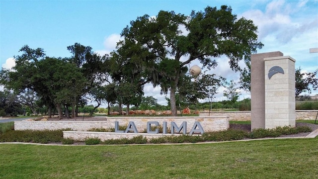 community / neighborhood sign with a yard