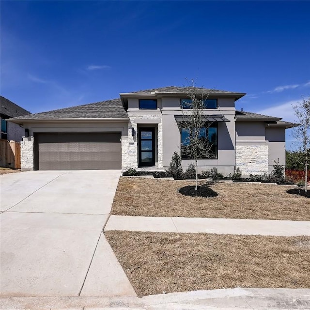 920 Teakmill Trl, San Marcos, TX 78666 - prairie-style home with stone siding, an attached garage, stucco siding, and driveway