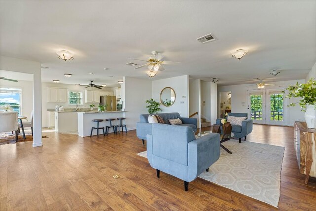 living room featuring plenty of natural light and light hardwood / wood-style floors