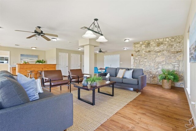 living room with ceiling fan and light hardwood / wood-style flooring