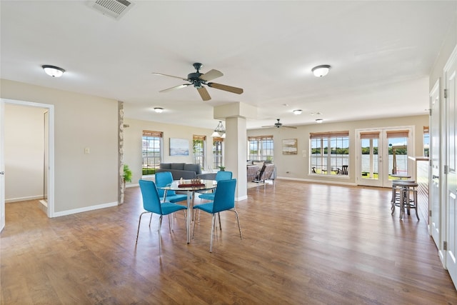 dining room with ceiling fan, wood-type flooring, and french doors