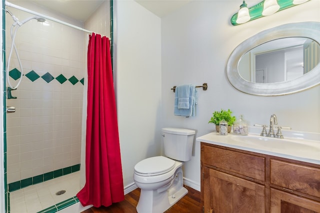 bathroom with toilet, hardwood / wood-style flooring, vanity, and curtained shower