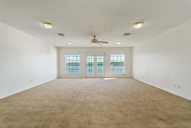 empty room with ceiling fan and carpet