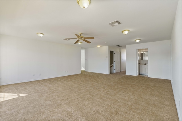 carpeted spare room with ceiling fan