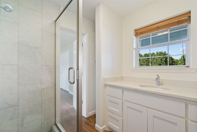 bathroom featuring vanity, a shower with door, and hardwood / wood-style flooring