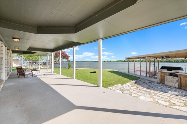 view of patio with a water view and area for grilling