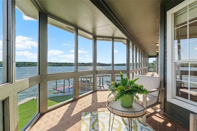 sunroom with plenty of natural light and a water view