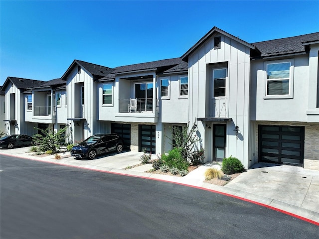 multi unit property with a balcony and a garage