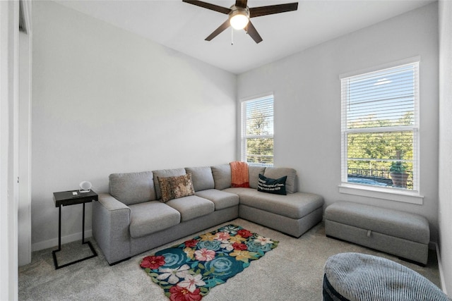 living room featuring light colored carpet and ceiling fan