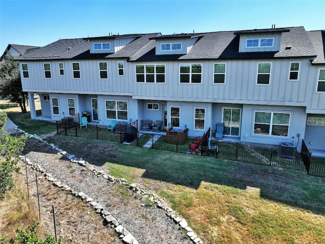 back of house with a patio, an outdoor living space, and a lawn