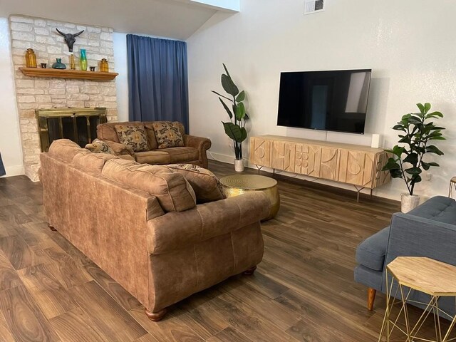 12404 Sceptre Cv, Austin, TX 78727 - living area featuring wood finished floors, lofted ceiling, and a fireplace