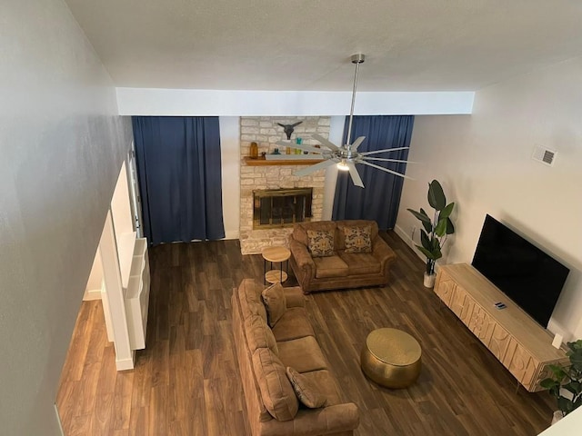 12404 Sceptre Cv, Austin, TX 78727 - living area featuring wood finished floors, a stone fireplace, and a ceiling fan