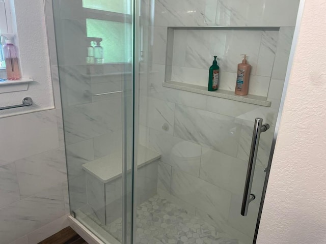 12404 Sceptre Cv, Austin, TX 78727 - full bathroom with a textured wall and a stall shower