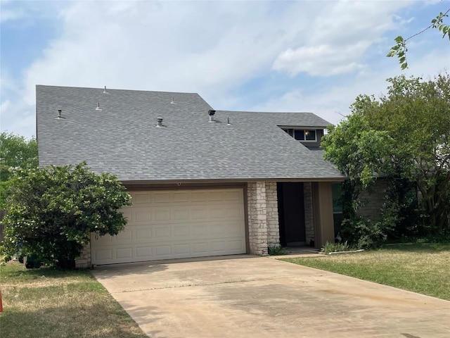view of front facade with roof with shingles, stone siding, a garage, and driveway