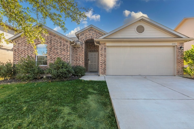 view of front of home with a garage and a front lawn