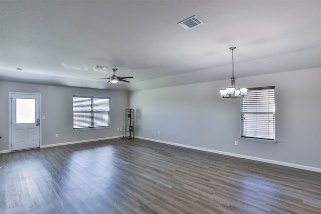 empty room featuring dark wood-type flooring and ceiling fan with notable chandelier