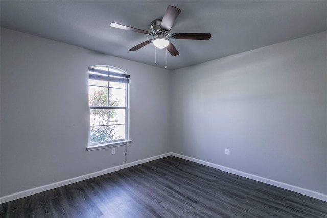 spare room with dark hardwood / wood-style floors and ceiling fan