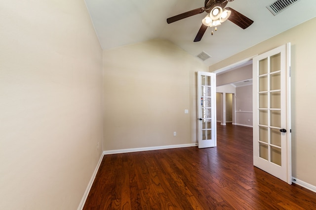 empty room with dark hardwood / wood-style flooring, vaulted ceiling, french doors, and ceiling fan