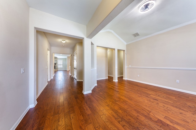 unfurnished room with crown molding, dark hardwood / wood-style flooring, and vaulted ceiling