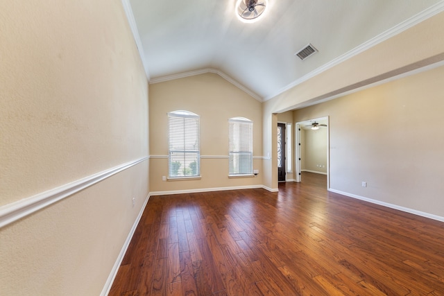 empty room with dark hardwood / wood-style flooring, vaulted ceiling, ornamental molding, and ceiling fan