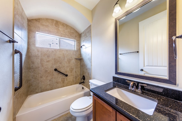 full bathroom featuring vaulted ceiling, toilet, vanity, and tiled shower / bath