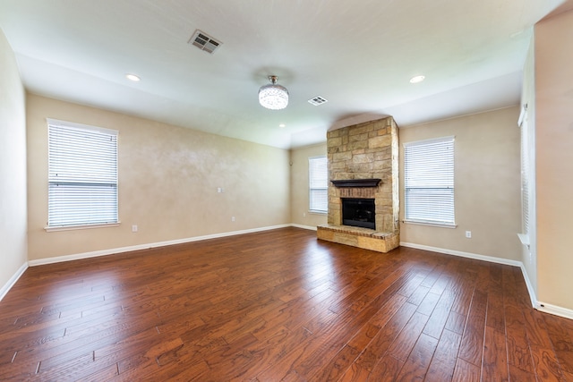 unfurnished living room featuring a fireplace and dark hardwood / wood-style flooring