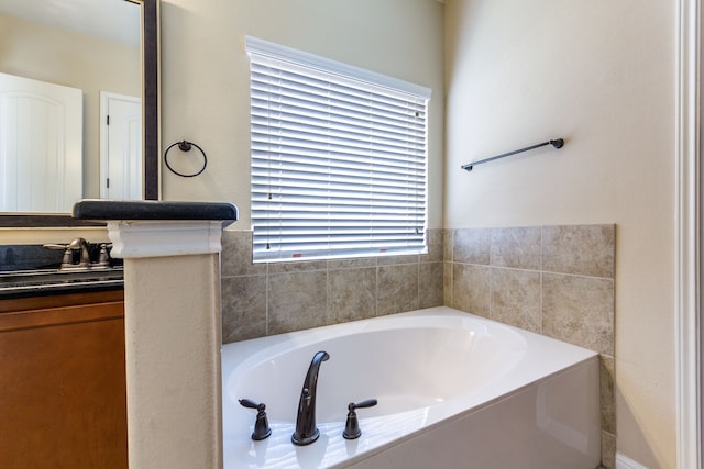 bathroom with vanity and a bathing tub