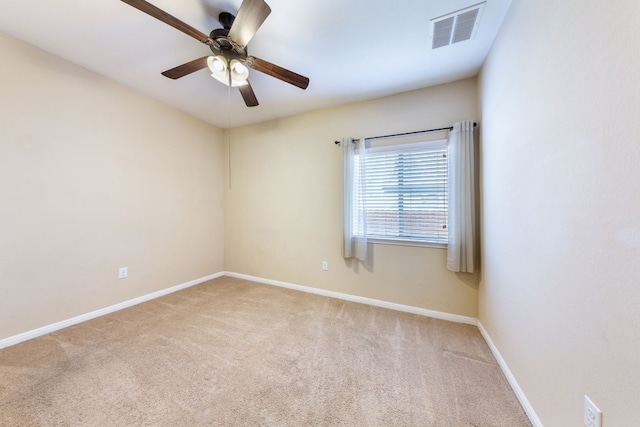 spare room with light colored carpet and ceiling fan