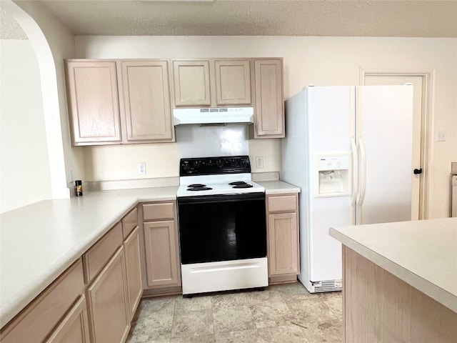 kitchen with light brown cabinetry and white appliances